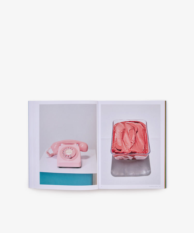 Open book displaying two photos: on the left page, a pink rotary phone sits atop a table; on the right, there's a container brimming with pink ice cream. The crisp white background creates a fresh, modern vibe—mirroring the iconic aesthetic of *The River Cafe Look Book: Recipes for Kids of all Ages*, renowned for its accessible recipes perfect for cooks at any level.
