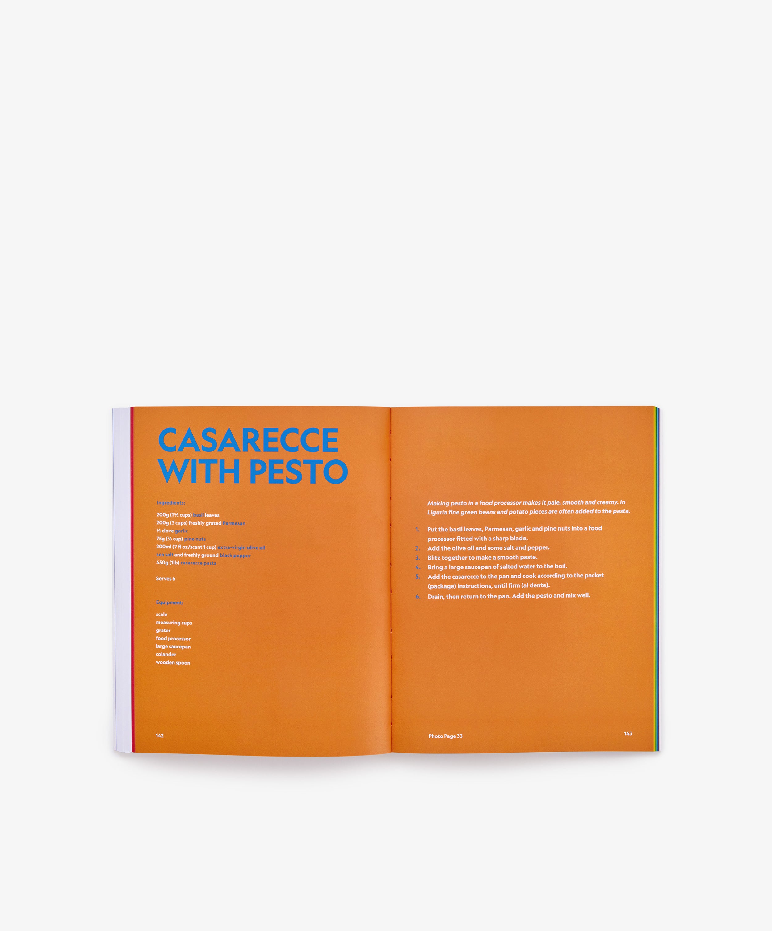An open copy of *The River Cafe Look Book: Recipes for Kids of all Ages* displays a Casarecce with Pesto recipe on an orange background, echoing the signature style of the celebrated River Cafe cookbook, with ingredients listed on the left page and step-by-step instructions on the right—ideal for those seeking beginner-friendly recipes inspired by London’s Michelin-starred restaurant classics.
