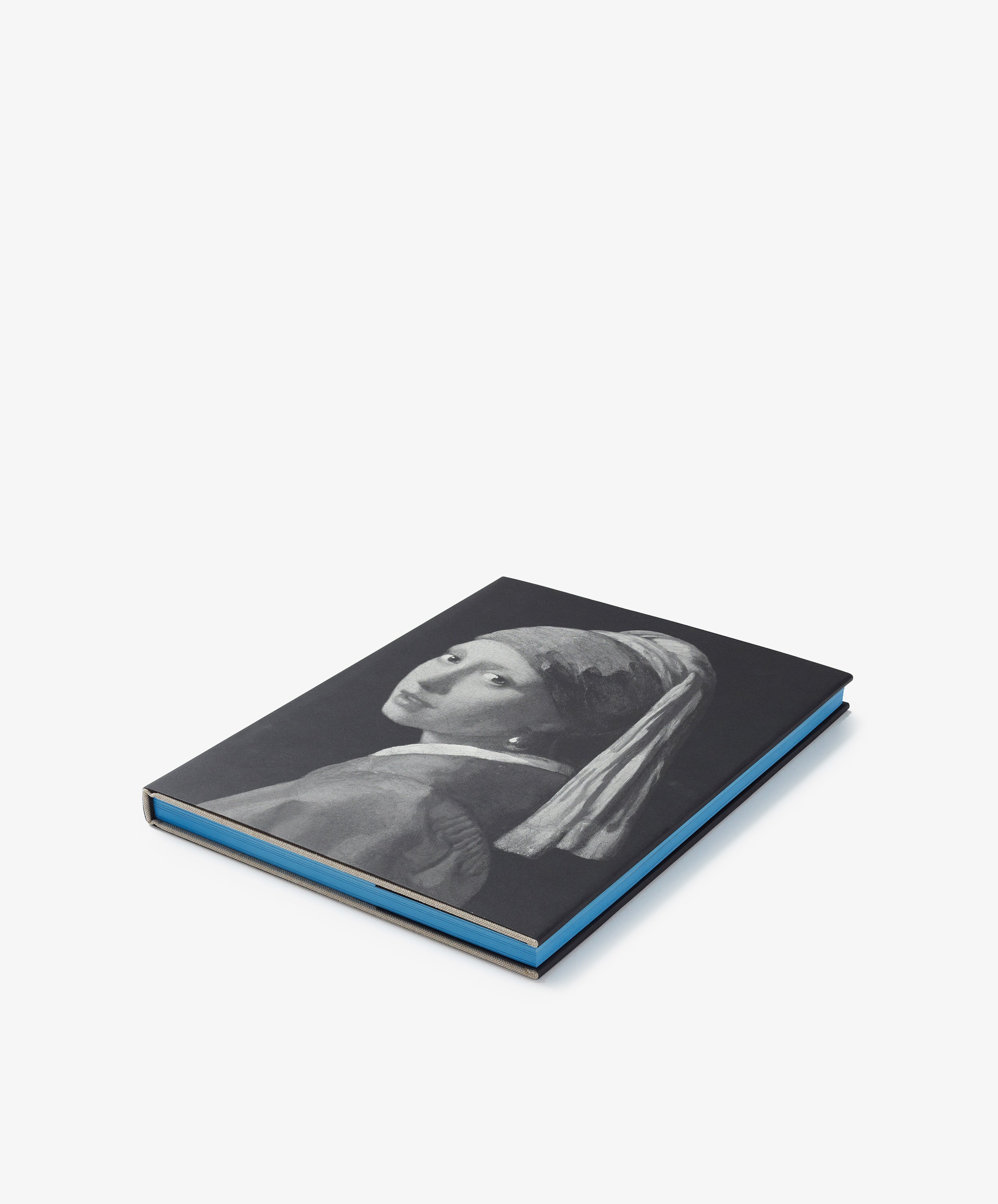 A closed black hardcover art book titled 