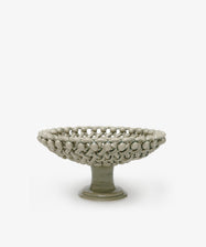 Decorative ceramic bowl with textured surface on a white background