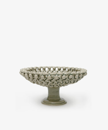 Decorative ceramic bowl with textured surface on a white background