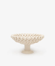 The Remi Footed Bowl features a white ceramic pedestal and open lattice design with hand-braided clay details—an elegant decorative fruit bowl or sculptural accent for any tabletop.