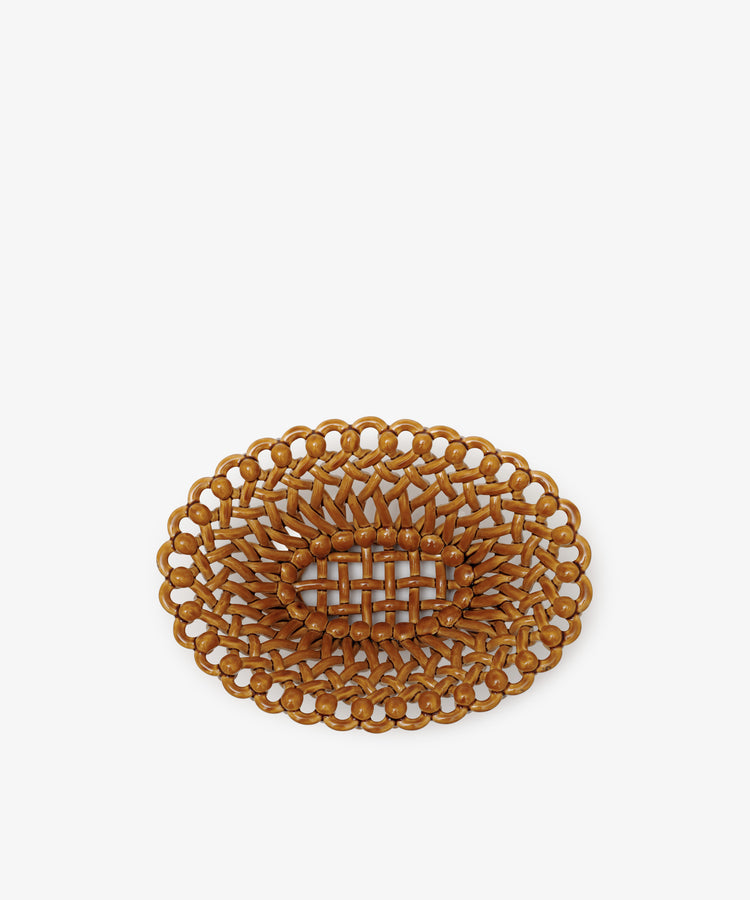 The Remi Decorative Fruit Bowl features an oval shape, woven rattan design, intricate looped border, and grid-like center, evoking sculptural elegance and displayed against a plain white background.