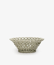 The Remi Decorative Flower Fruit Bowl features a shallow, round ceramic shape with an open lattice design and twisted rope-like rim and base, making it a striking sculptural centerpiece for displaying fruit on any plain white background.