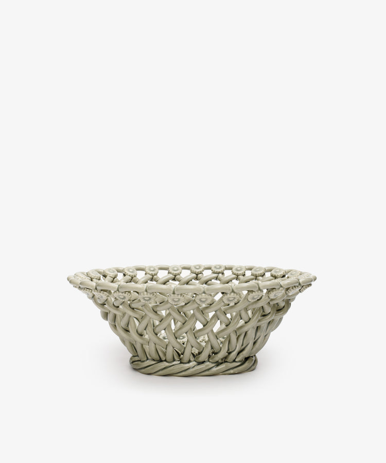 The Remi Decorative Flower Fruit Bowl features a shallow, round ceramic shape with an open lattice design and twisted rope-like rim and base, making it a striking sculptural centerpiece for displaying fruit on any plain white background.
