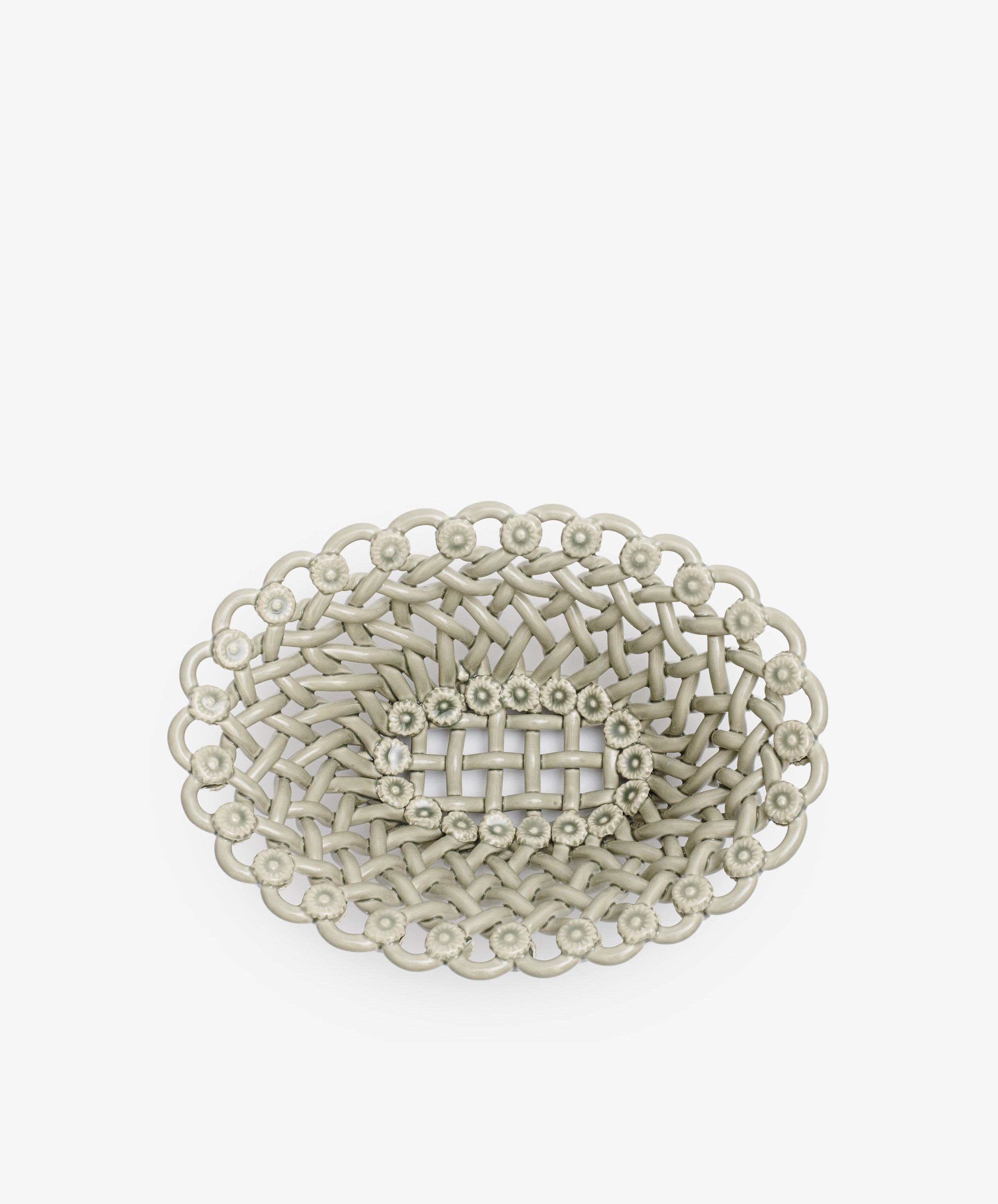 The Remi Decorative Flower Fruit Bowl is an oval-shaped, light gray woven basket with a scalloped edge and sculptural center, perfect as a statement fruit bowl and displayed on a white background.