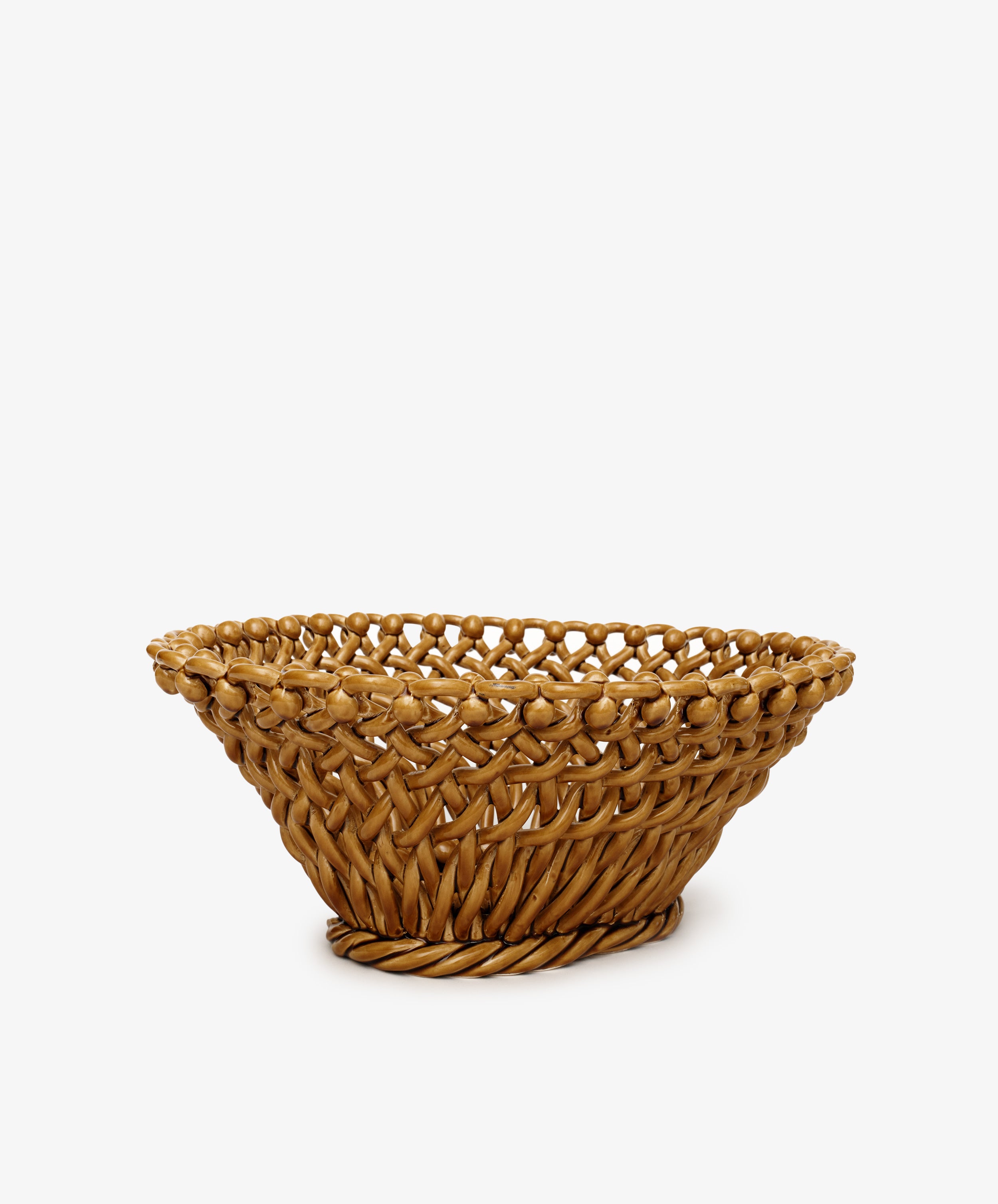 The Remi Decorative Fruit Bowl is a round, woven wicker basket with an open top and slightly flared rim, displayed elegantly against a plain white background.