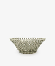 The Remi Decorative Fruit Bowl is a shallow, round, light gray ceramic basket with an open lattice design that makes a striking sculptural statement, shown here as a decorative accent against a plain white background.