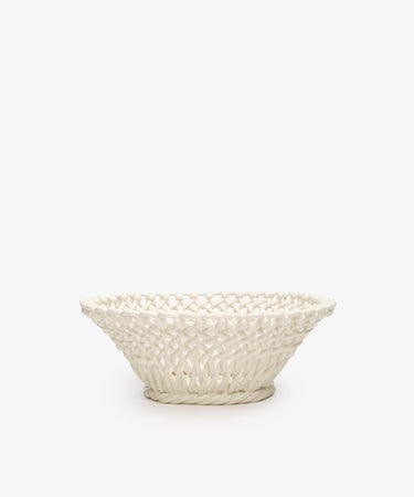 The Remi Decorative Fruit Bowl is a white ceramic woven basket with a wide rim and intricate lattice design, inspired by South of France craftsmanship—perfect as an elegant accent for your home.