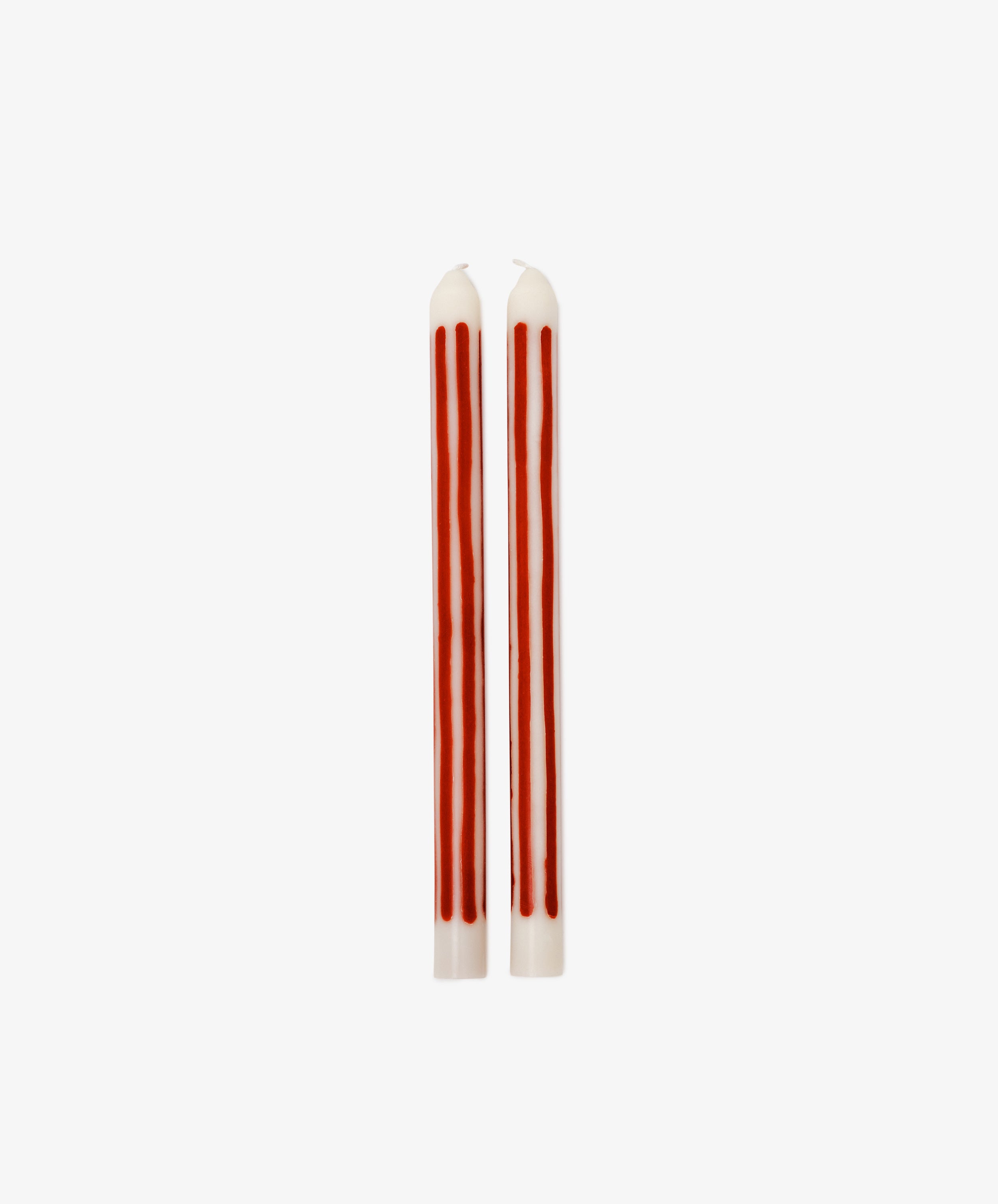The Beckford Candle features two white taper candles with vertical red stripes, perfect for adding a touch of elegance to any setting.