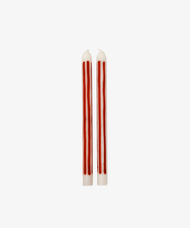 The Beckford Candle features two white taper candles with vertical red stripes, perfect for adding a touch of elegance to any setting.