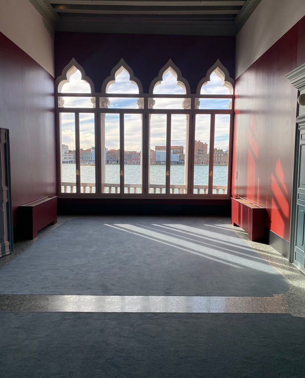 interior of room with windows showing the water and city 