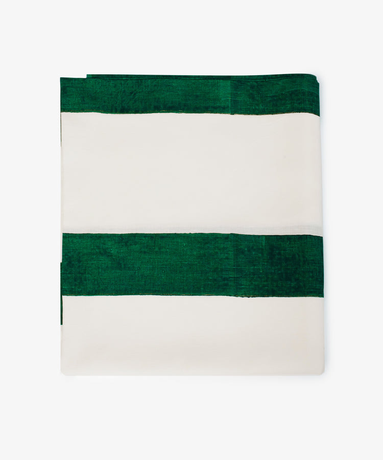 The Riga Tablecloth is an artisanal linen piece with wide horizontal green and white stripes on a plain background, neatly folded for display.
