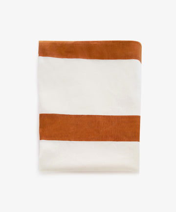 Riga tablecloth. Folded rectangular white linen cloth with thick rust stripes.

