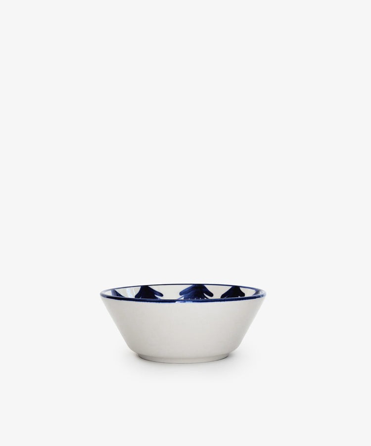 The Catalina Cereal Bowl, Set of 4, features small white hand-painted ceramic bowls with blue geometric patterns around the rim, inspired by traditional Portuguese designs. Set against a plain white background.