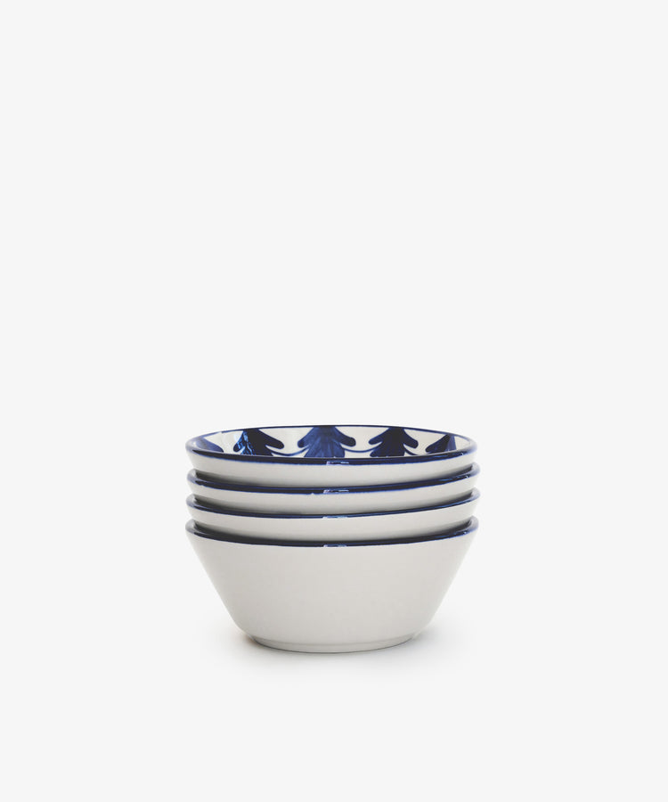 The Catalina Cereal Bowl, Set of 4, features hand-painted ceramic bowls with a dark blue rim pattern. Crafted in Portugal for timeless elegance, these bowls are displayed against a plain white background.