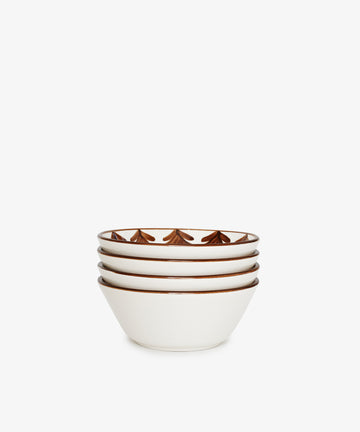 The Catalina Cereal Bowl set includes four white ceramic bowls, each featuring a hand-painted brown geometric pattern along the inner rim, shown stacked against a plain white background.