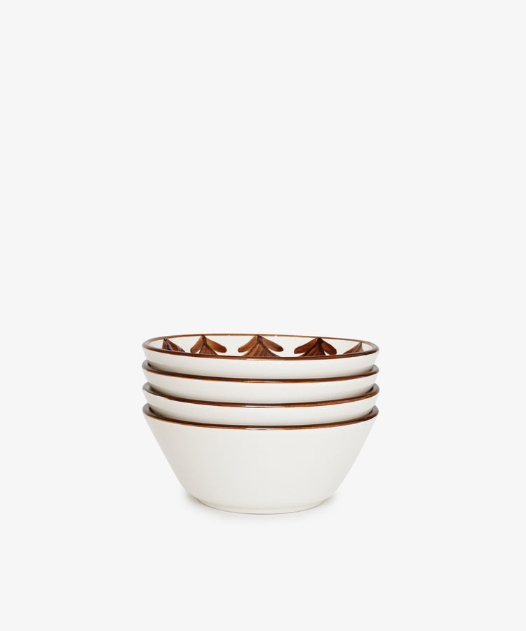 The Catalina Cereal Bowl set includes four white ceramic bowls, each featuring a hand-painted brown geometric pattern along the inner rim, shown stacked against a plain white background.