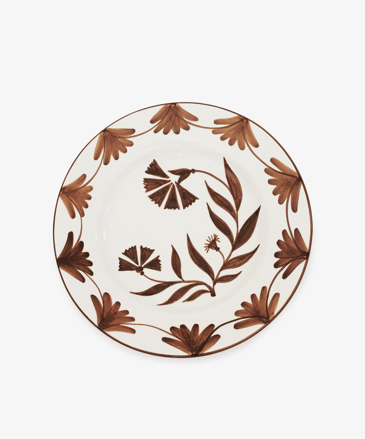 The Catalina Dinner Plate, Set of 4, features a white base with an espresso floral pattern of two stylized central flowers and a leaf border, expertly crafted by a handmade ceramicist.