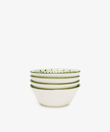 A set of four Esmeralda Cereal Bowls, featuring white ceramic with green patterned rims and a subtle floral design, is displayed on a plain white background.