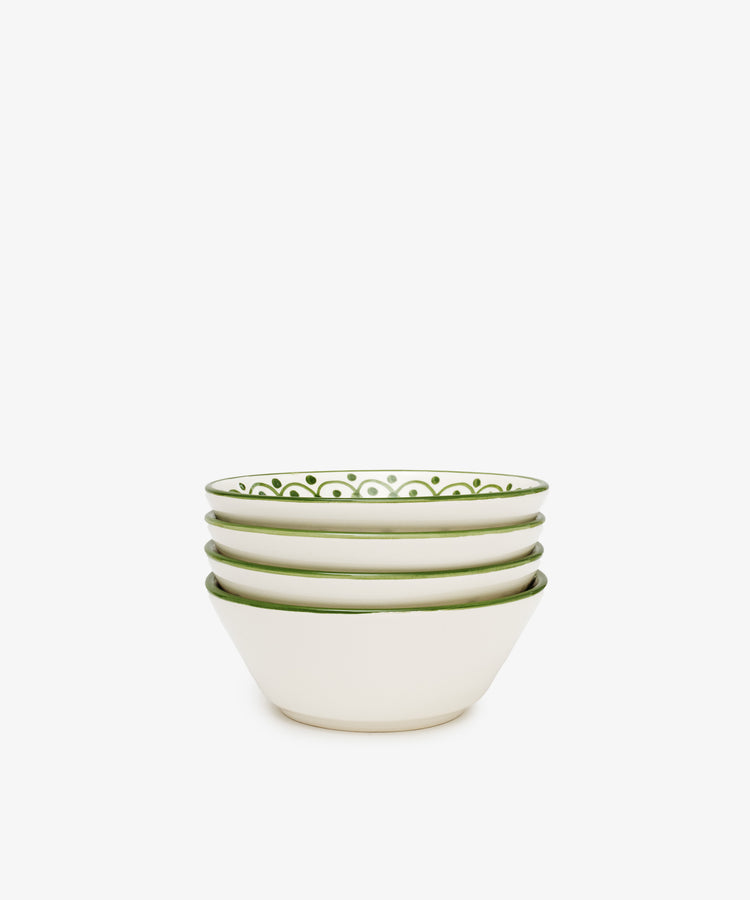 A set of four Esmeralda Cereal Bowls, featuring white ceramic with green patterned rims and a subtle floral design, is displayed on a plain white background.