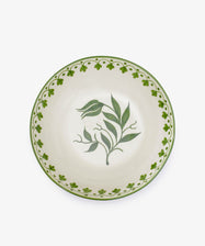 The Esmeralda Serving Bowl is a round, hand-painted ceramic bowl with a green floral center and a green patterned border on a white background.