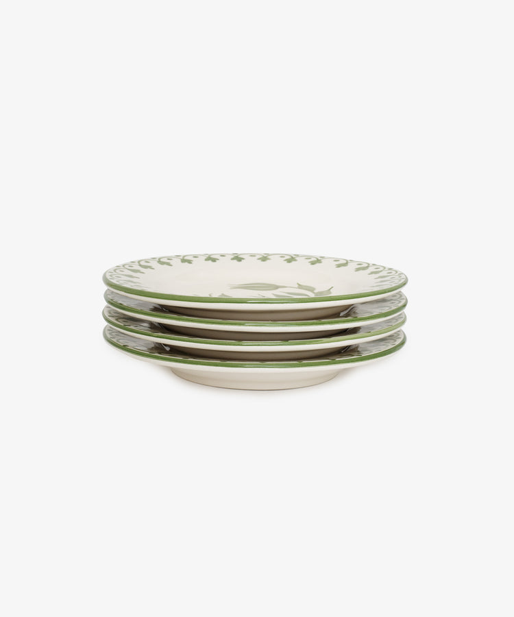 A set of four Esmeralda small ceramic plates features a green decorative rim and hand-painted leaf pattern in the center, displayed against a white background.