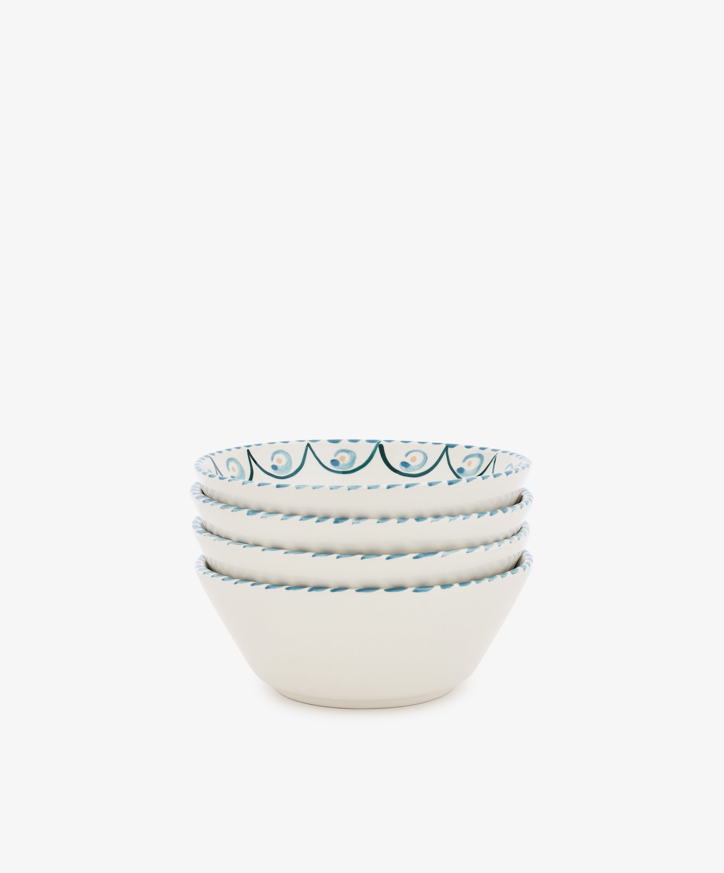 The Ottoline Cereal Bowl set includes four white ceramic bowls, each hand-painted with a blue decorative pattern inspired by Tess Newall, shown stacked together against a plain white background.