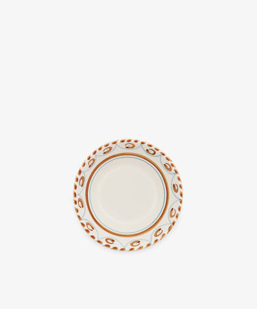 The Ottoline Cereal Bowl, Set of 4, features a cream center with a decorative brown and blue patterned rim from the Tess Newall collection. Photographed on a plain white background, these artisanal bowls add charm to any table setting.