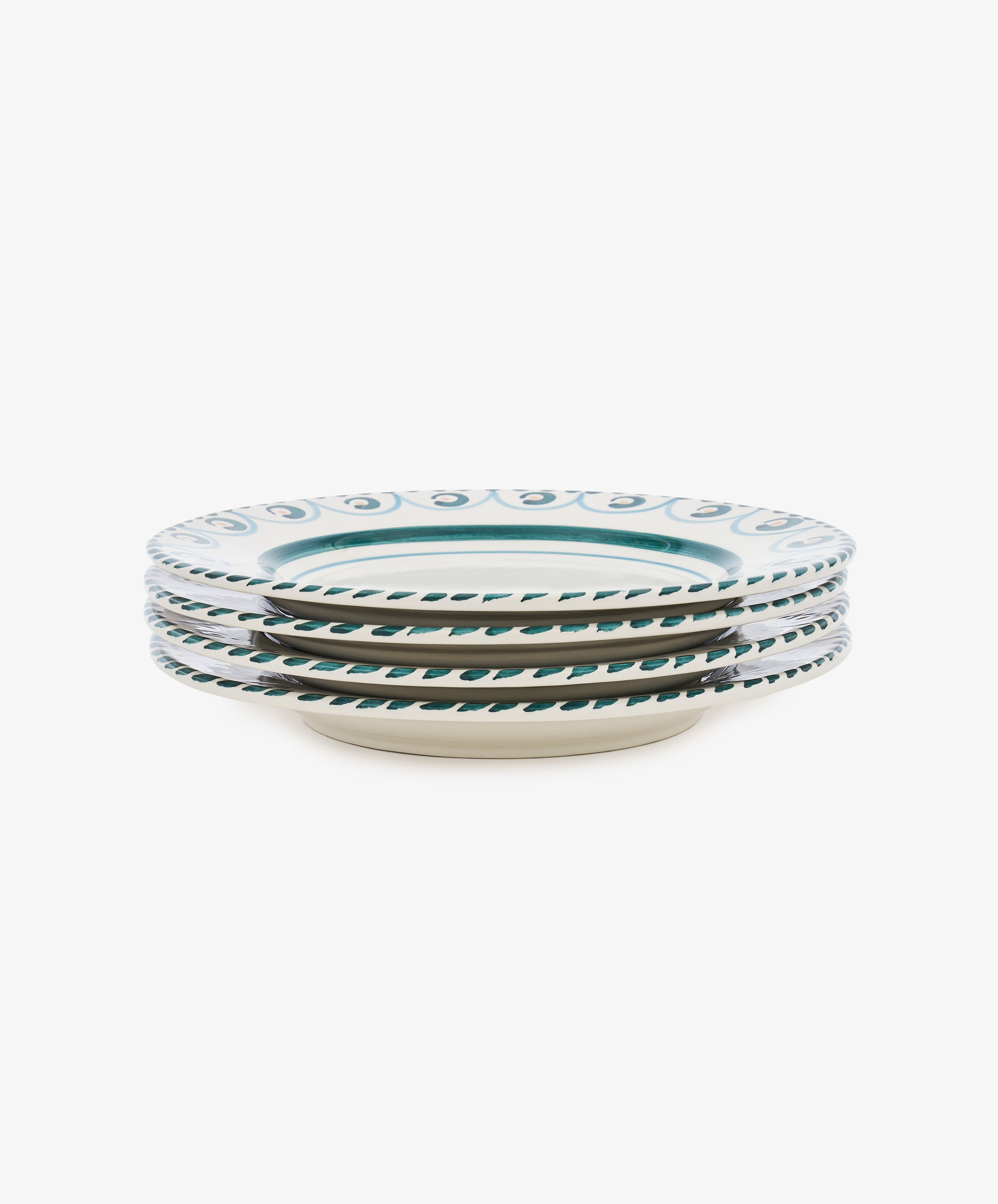 A side view of four hand-painted Ottoline Dinner Plates, each with a white base and blue-green decorative rim, shown against a white background. Part of the Tess Newall collection.