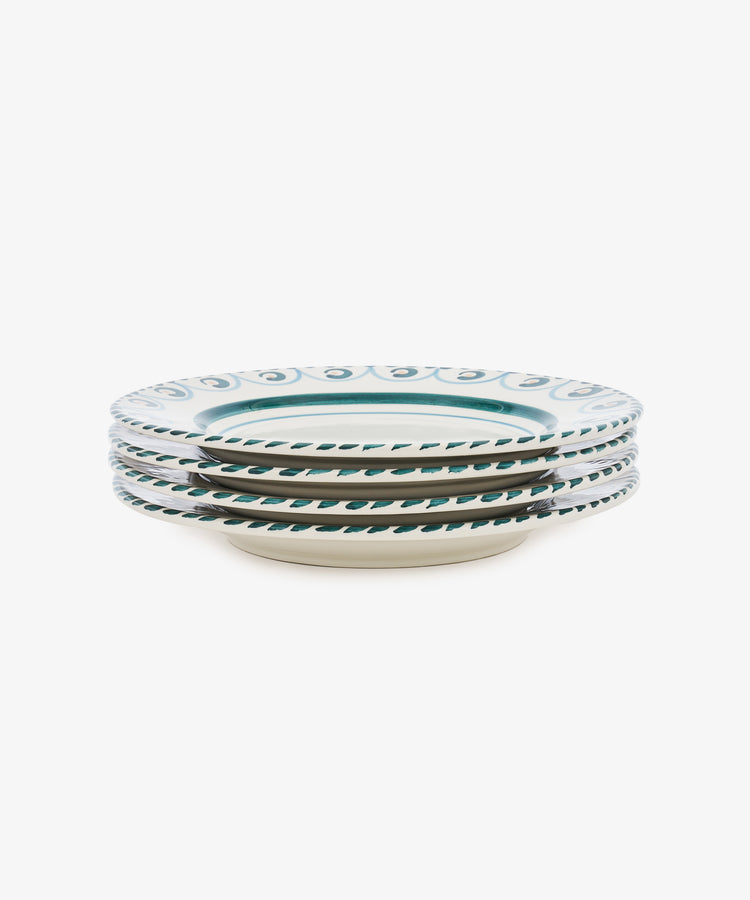 A side view of four hand-painted Ottoline Dinner Plates, each with a white base and blue-green decorative rim, shown against a white background. Part of the Tess Newall collection.