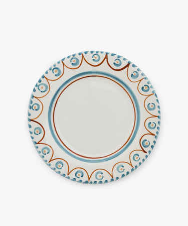 The Ottoline Dinner Plate, Set of 4, features round ceramic plates with white centers and decorative blue and brown rims inspired by Tess Newall’s hand-painted designs, shown against a plain white background.