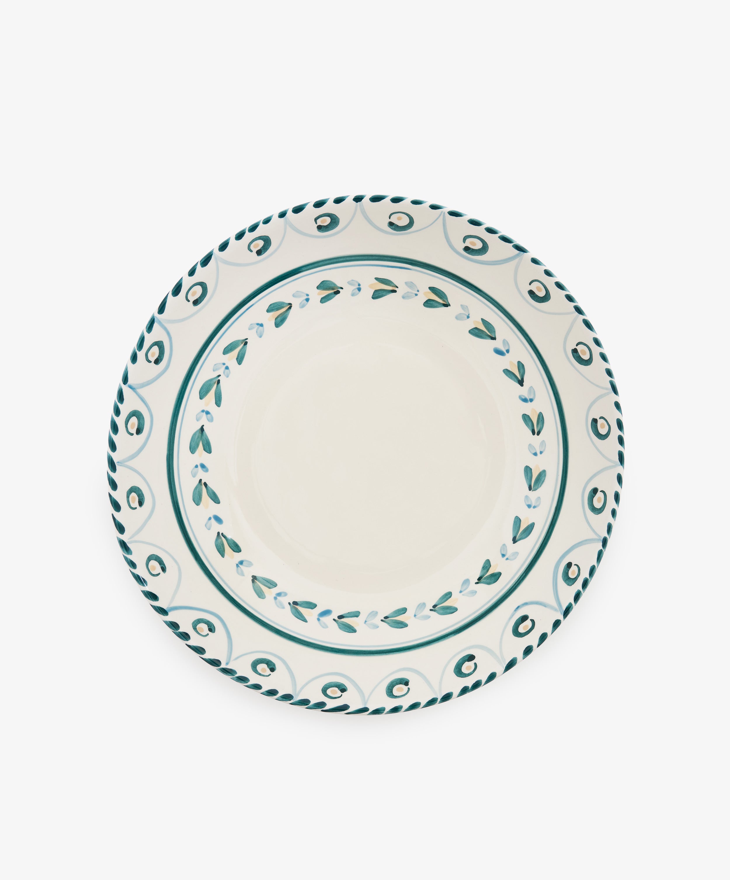 Ottoline Serving Bowl with a white center and decorative teal pattern around the rim, reminiscent of a Tess Newall hand-painted piece, photographed from above on a white background.