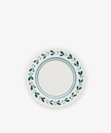 The Ottoline Small Plate, Set of 4, features round white ceramic plates hand-painted with a blue and green leafy rim pattern, viewed from above against a white background; part of the Tess Newall collection.