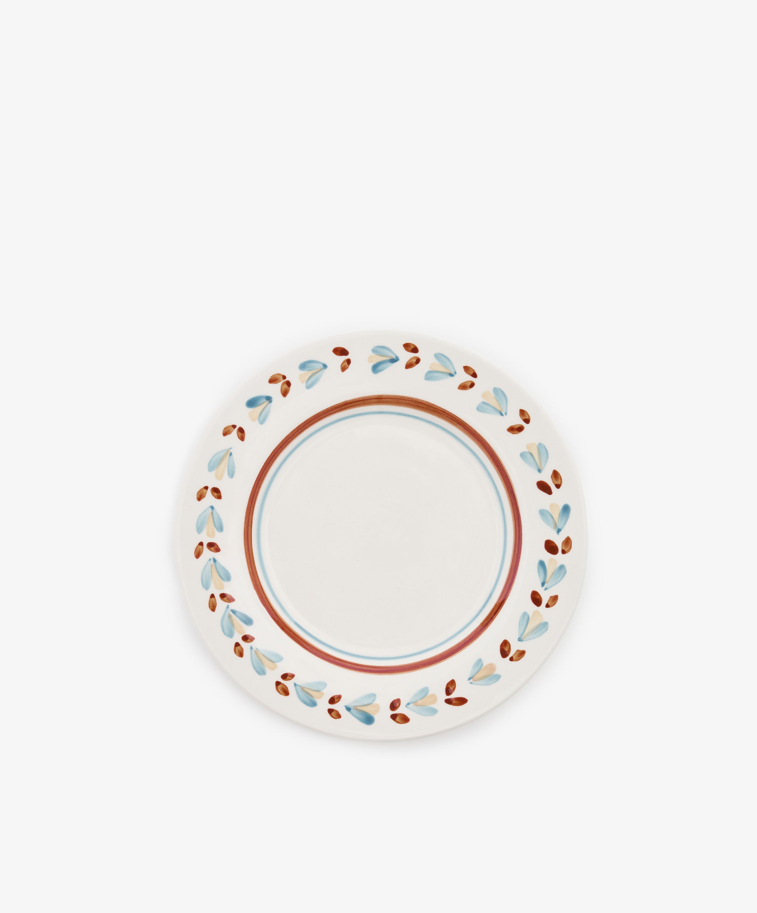 The Ottoline Small Plate, Set of 4, features round ceramic plates with white centers and decorative blue and brown leaf-patterned borders, inspired by hand-painted designs from Tess Newall's Charleston collection.
