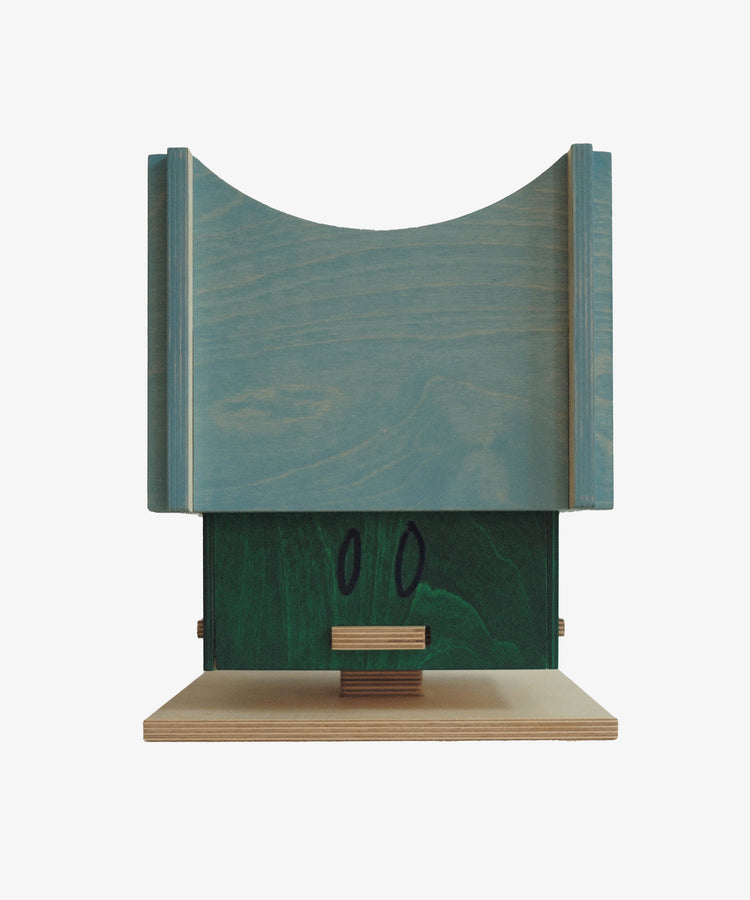 The Milo Keepsake Box by PORTA House of RoRo showcases a geometric wooden design with blue and green stained accents, a curved top, and rectangular base, making it stand out against a white background.