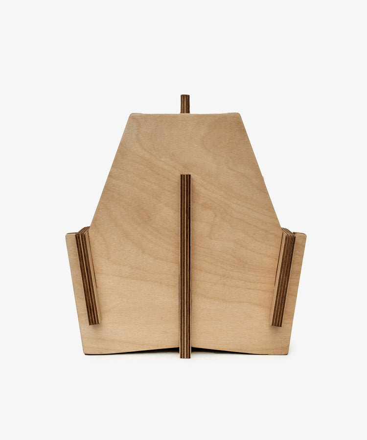 The Casper Caddy by House of RoRo is a geometric wooden storage caddy with angled sides and vertical slats, ideal for kids’ storage. Photographed against a white background.