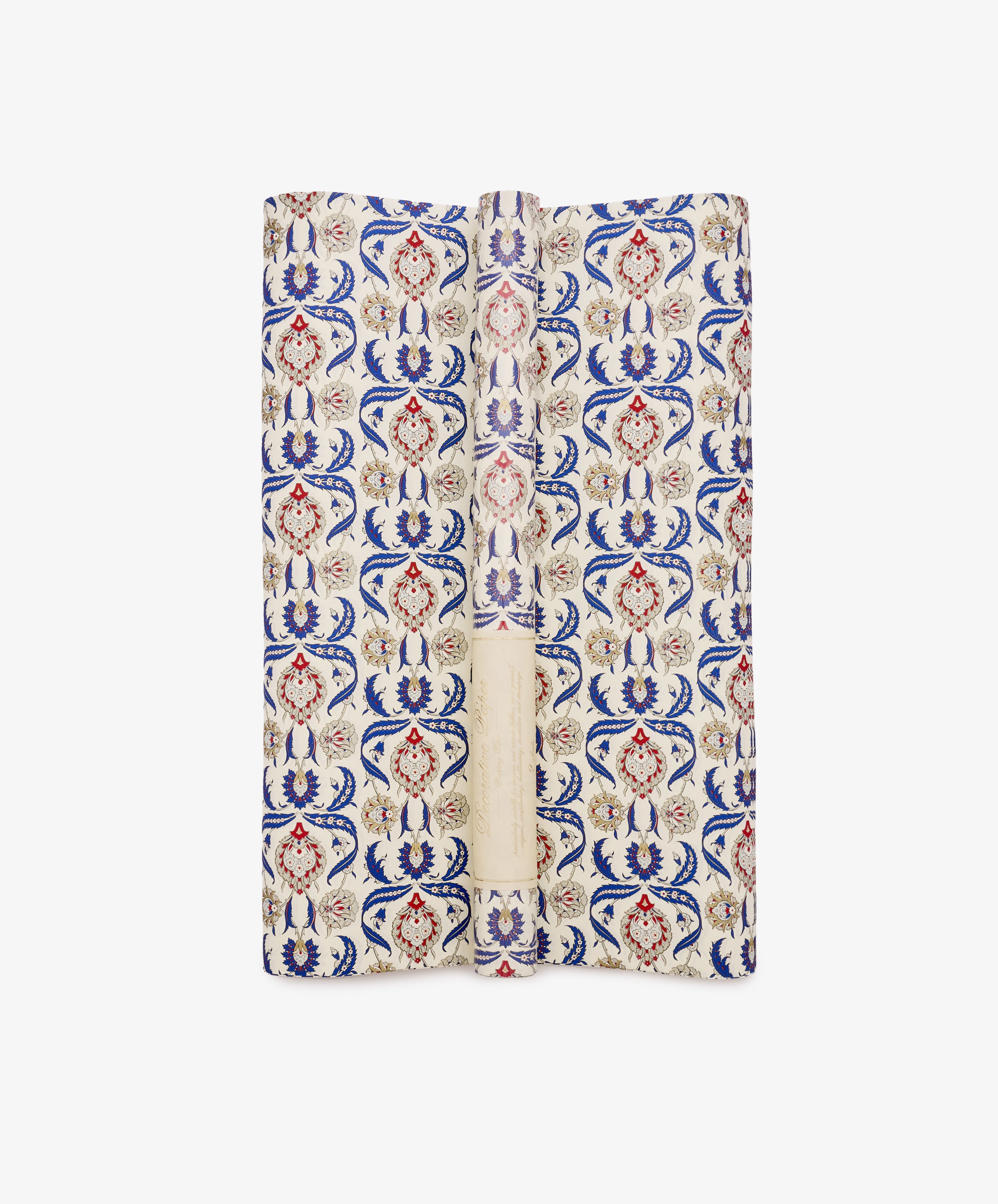 Arabesque Gift Wrap, featuring a repeating pattern of blue, red, and beige floral motifs with decorative Arabesque designs on a cream background, is displayed folded against a white surface.