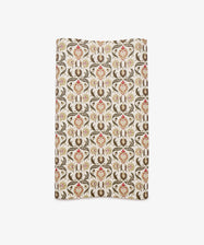 Arabesque Gift Wrap featuring a repeating ornate floral and vine pattern in brown, red, and beige tones on a white background.