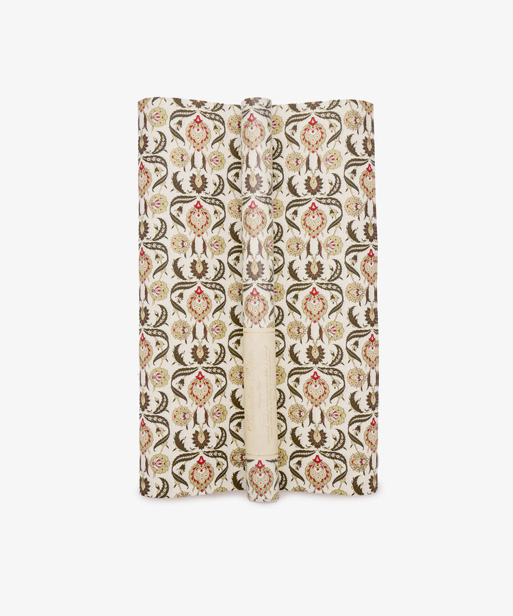 Arabesque Gift Wrap with a patterned floral and vine motif featuring a delicate arabesque design, shown spread out and facing upwards against a white background.
