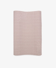 Lilies Gift Wrap—rectangular sheet featuring a small red geometric pattern on a white background—displayed against a plain white surface.