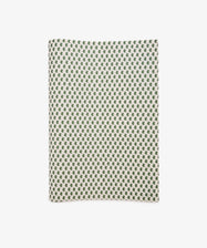 A sheet of Rampant Lions Gift Wrap featuring a repeating small green geometric floral pattern on a cream background is shown folded and displayed flat on a white surface.