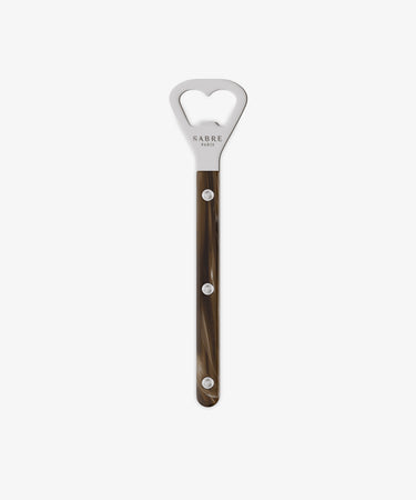 The Bottle Opener features a long, brown marbled handle with three silver rivets, inspired by Sabre’s classic French Bistrot cutlery set and displayed against a plain white background.