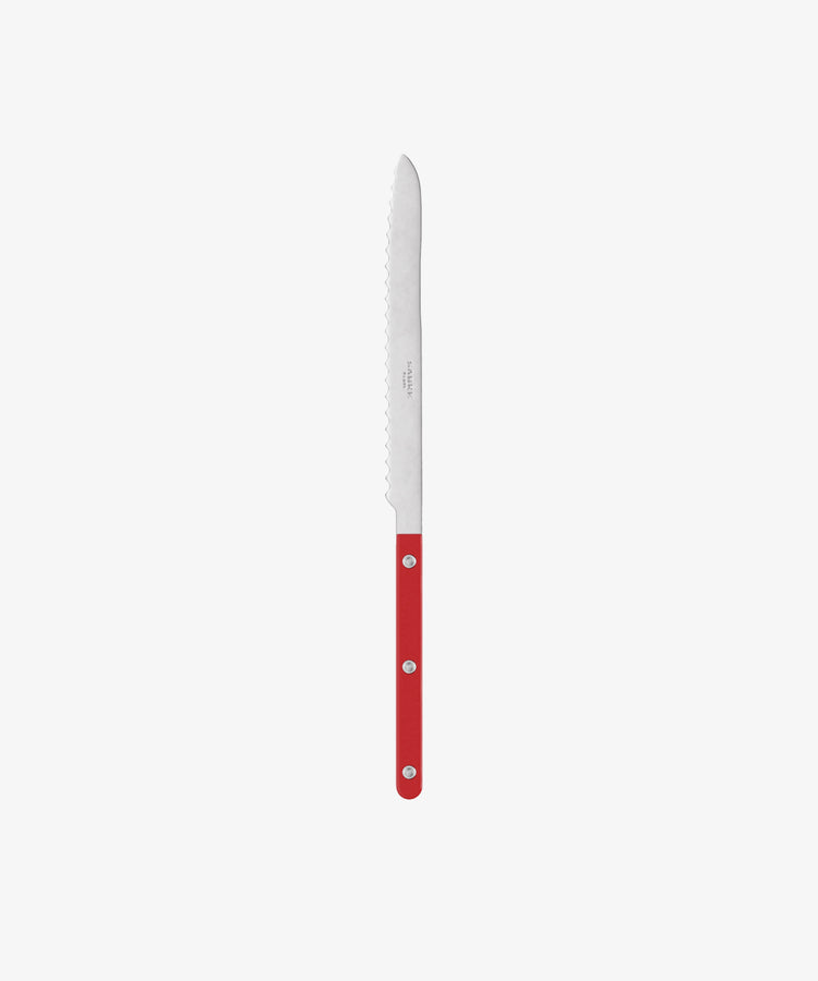 The Bistrot Bread Knife has a long, serrated stainless steel blade and a vibrant red handle—an essential kitchen tool, pictured on a plain white background.