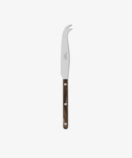 The Large Cheese Knife, inspired by French bistrot cutlery, has a curved stainless steel blade, forked tip, and a dark brown handle with three metal rivets, displayed on a white background.
