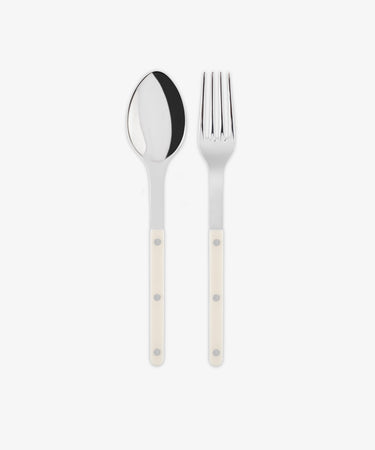 The Bistrot Serving Set features a stainless steel spoon and fork with white handles, arranged side by side on a white background, capturing subtle French flair and classic Parisian bistro style.