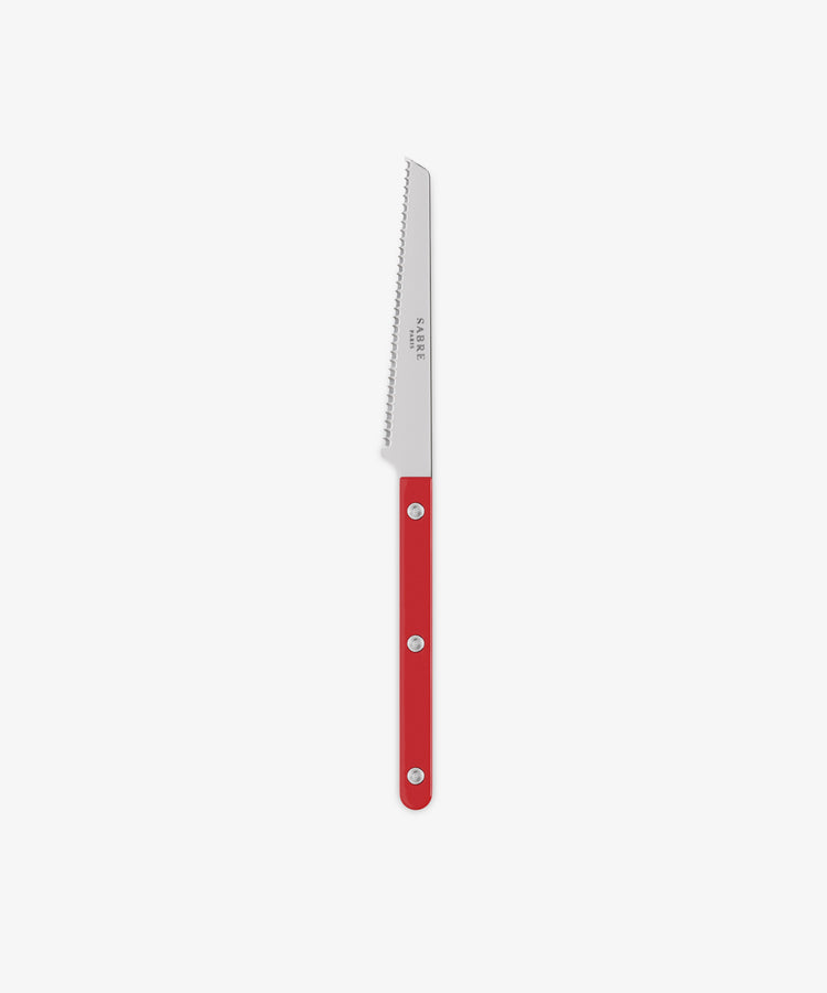 A Tomato Knife with a serrated silver blade and a red handle featuring three metal rivets, displayed on a plain white background.
