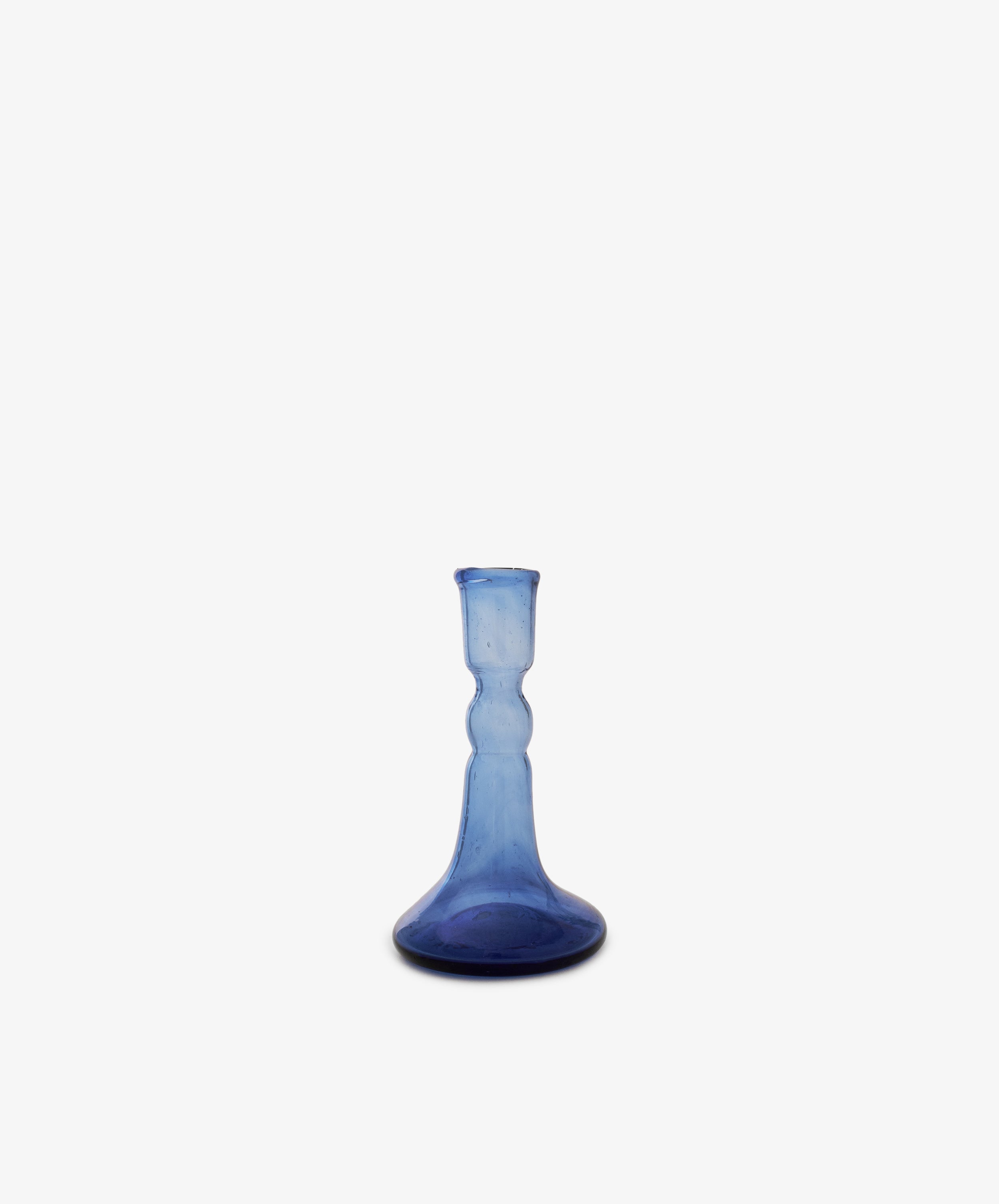 The Lucia candleholder is a small, blue glass piece with a flared base and narrow neck, ideal for taper candles, shown against a plain white background.