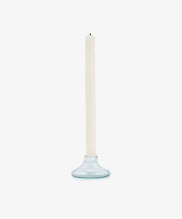 The Lucien candleholder, Small—crafted from handmade recycled glass—holds a white taper candle upright against a plain white background.