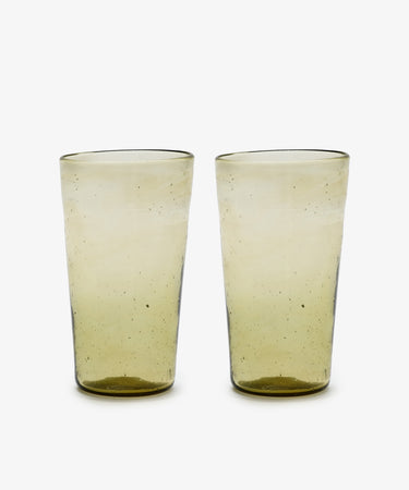 A set of six Elodie Water Glasses, handblown in Morocco from translucent yellow-tinted recycled glass with a slightly irregular shape, displayed on a white background.